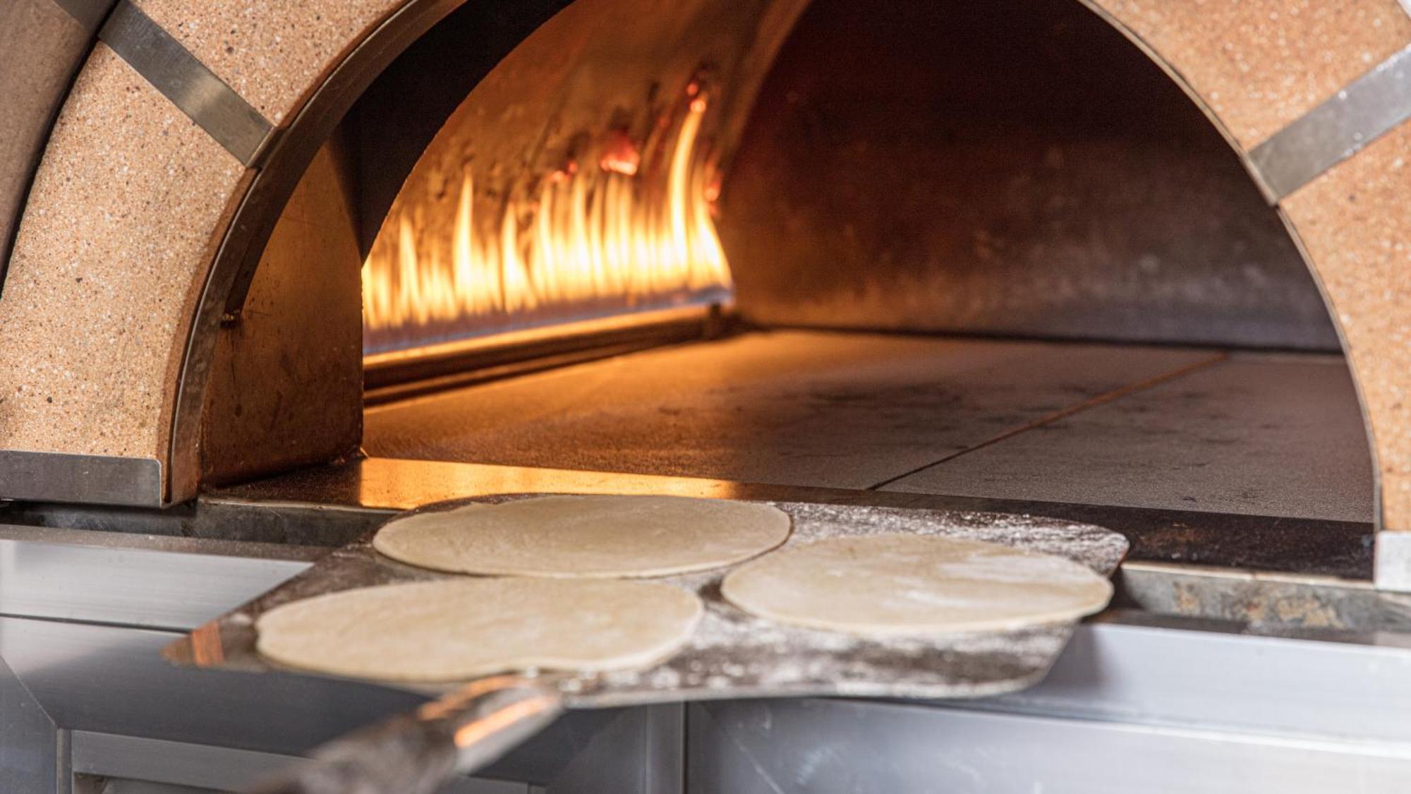 The Abdali Boulevard Hotel Amán Exterior foto Pizza dough in a wood-fired oven